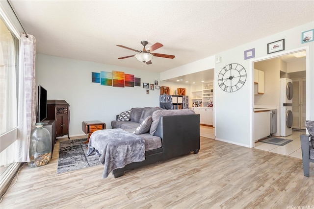 1022 Prospect St Unit 704A, Honolulu, HI 96822 - living room with a ceiling fan, light wood-type flooring, stacked washer / drying machine, and a textured ceiling
