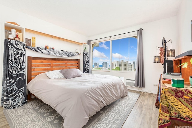 1022 Prospect St Unit 704A, Honolulu, HI 96822 - bedroom featuring a view of skyline and wood finished floors