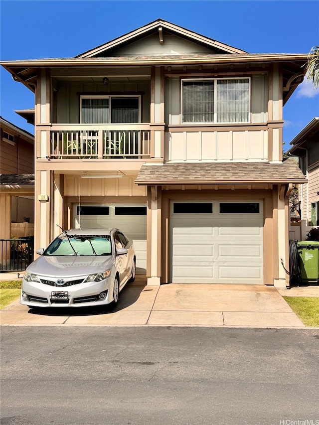 91-1200 Keaunui Dr Unit 309, Ewa Beach, HI 96706 - view of front of home featuring concrete driveway, a garage, a balcony, and roof with shingles