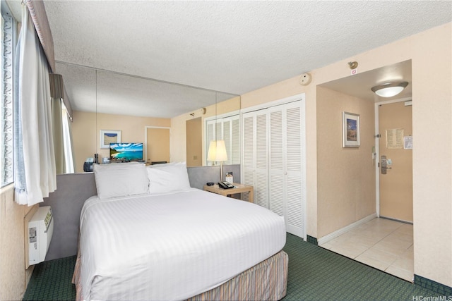 444 Kanekapolei St Unit 513, Honolulu, HI 96815 - carpeted bedroom featuring a closet, a textured ceiling, and tile patterned flooring