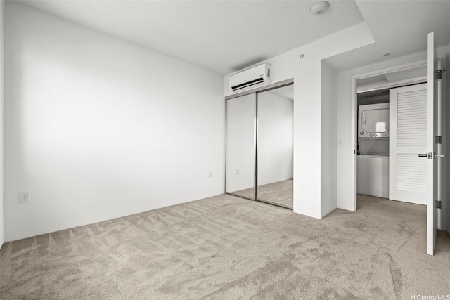 615 Keawe St Unit 3005, Honolulu, HI 96813 - unfurnished bedroom with stacked washer / dryer, a wall unit AC, carpet, and a closet