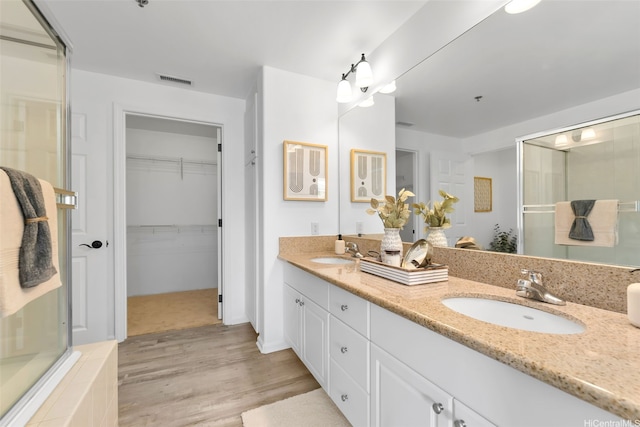 520 Lunalilo Home Rd Unit 6419, Honolulu, HI 96825 - bathroom featuring an enclosed shower, double vanity, wood finished floors, and a walk in closet