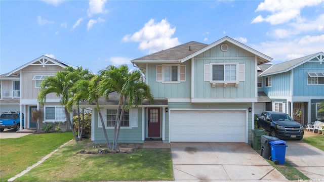87-1106 Oheohe St, Waianae, HI 96792 - view of front facade featuring driveway, an attached garage, a front lawn, and board and batten siding