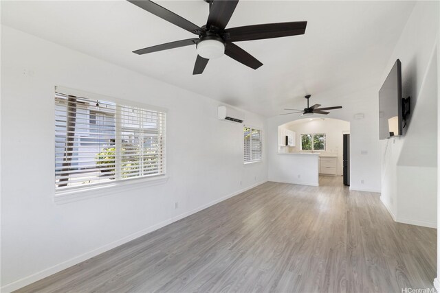 87-1106 Oheohe St, Waianae, HI 96792 - unfurnished living room featuring ceiling fan, light wood-type flooring, and an AC wall unit