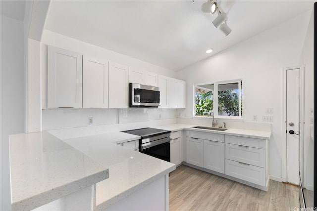 87-1106 Oheohe St, Waianae, HI 96792 - kitchen featuring stainless steel appliances, a peninsula, light stone countertops, white cabinets, and light wood-type flooring