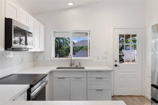 87-1106 Oheohe St, Waianae, HI 96792 - kitchen with stainless steel appliances, healthy amount of natural light, white cabinets, and light countertops