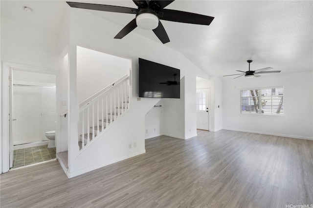 87-1106 Oheohe St, Waianae, HI 96792 - unfurnished living room with a ceiling fan, wood finished floors, stairway, and lofted ceiling