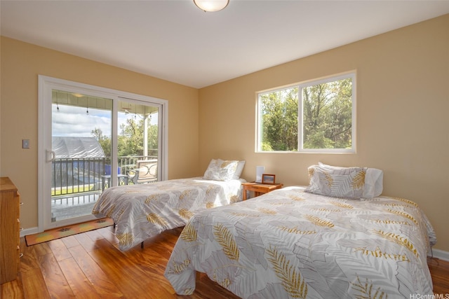 11-3064 Lehua St, Mountain View, HI 96771 - bedroom with access to outside, multiple windows, and wood finished floors