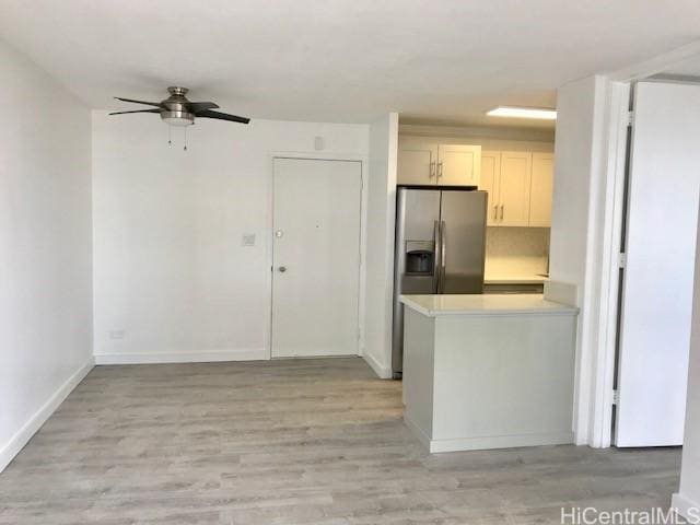 775 Kinalau Pl Unit 1204, Honolulu, HI 96813 - kitchen featuring a ceiling fan, light countertops, stainless steel refrigerator with ice dispenser, light wood-type flooring, and a peninsula