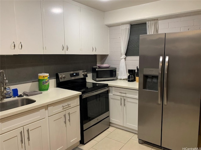 410 Nahua St Unit 204, Honolulu, HI 96815 - kitchen with appliances with stainless steel finishes, light countertops, and white cabinetry