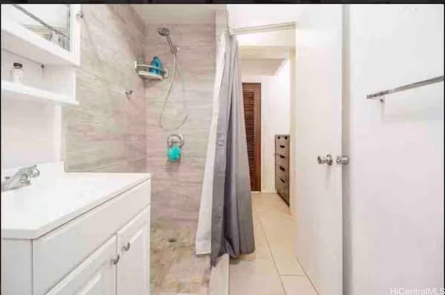 410 Nahua St Unit 204, Honolulu, HI 96815 - full bathroom with a tile shower, vanity, and tile patterned floors