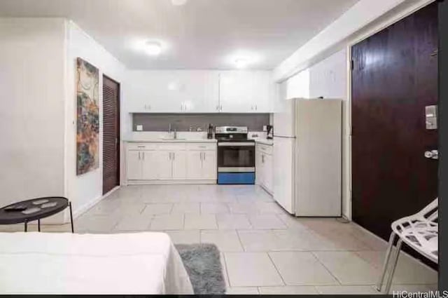 410 Nahua St Unit 204, Honolulu, HI 96815 - kitchen featuring freestanding refrigerator, stainless steel electric range oven, white cabinets, and light countertops