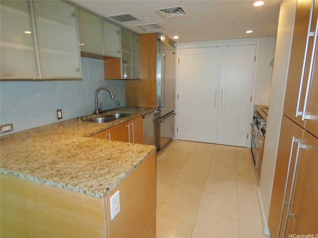 1177 Queen St Unit 3405, Honolulu, HI 96814 - kitchen with stainless steel appliances, light stone countertops, light tile patterned floors, recessed lighting, and a peninsula