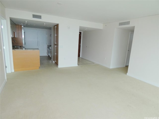 1177 Queen St Unit 3405, Honolulu, HI 96814 - unfurnished living room featuring light colored carpet and baseboards