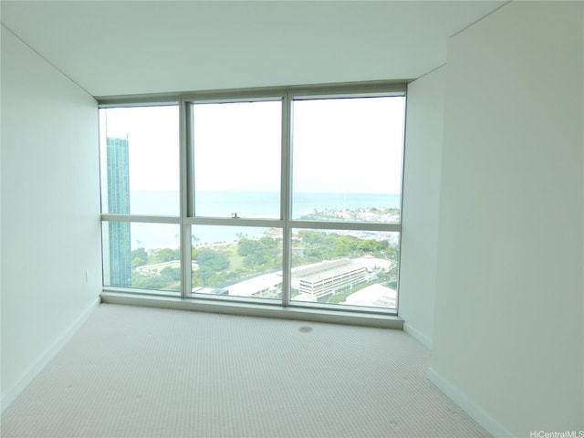 1177 Queen St Unit 3405, Honolulu, HI 96814 - carpeted empty room featuring a water view and baseboards