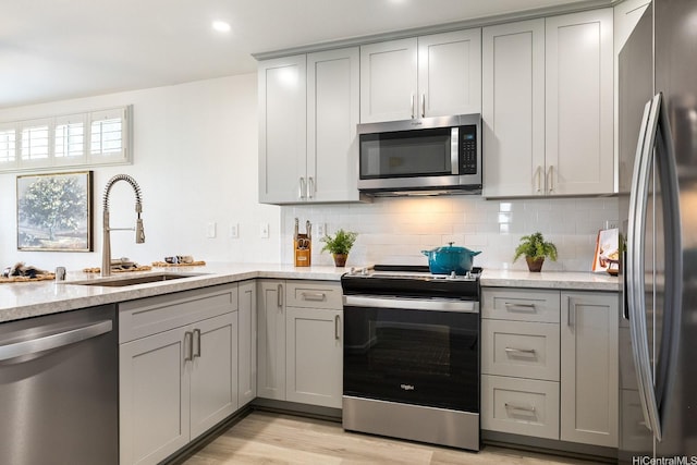 91-497 Kuhialoko St, Ewa Beach, HI 96706 - kitchen with stainless steel appliances, gray cabinetry, decorative backsplash, light stone countertops, and recessed lighting