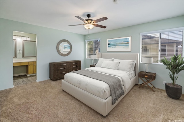91-324 Kailike Pl, Ewa Beach, HI 96706 - bedroom featuring light colored carpet, connected bathroom, an office area, and a ceiling fan
