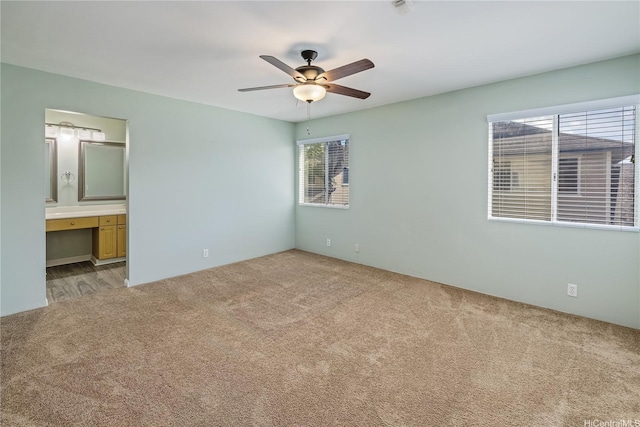 91-324 Kailike Pl, Ewa Beach, HI 96706 - unfurnished bedroom with carpet floors, connected bathroom, built in desk, and ceiling fan
