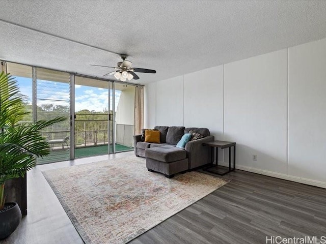 95-2055 Waikalani Pl Unit B404, Mililani, HI 96789 - living room with floor to ceiling windows, a ceiling fan, dark wood-style floors, and a textured ceiling