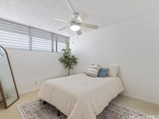 95-2055 Waikalani Pl Unit B404, Mililani, HI 96789 - bedroom with light colored carpet, a textured ceiling, and a ceiling fan