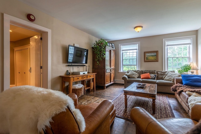 living room with plenty of natural light, a baseboard radiator, and dark wood-type flooring