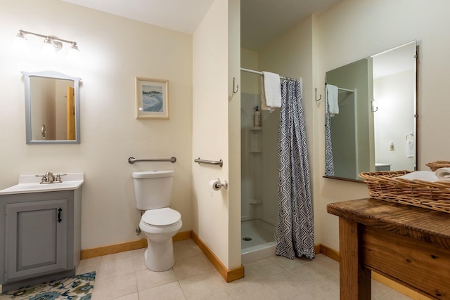 bathroom with toilet, tile floors, a shower with shower curtain, and vanity