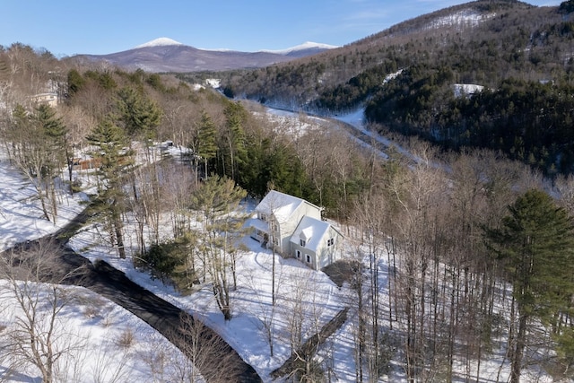 snowy aerial view with a mountain view