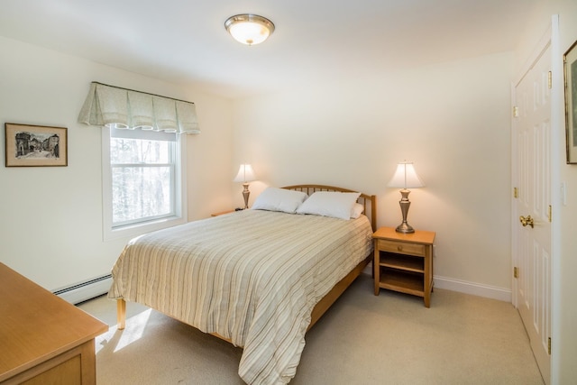 bedroom featuring light colored carpet and a baseboard heating unit