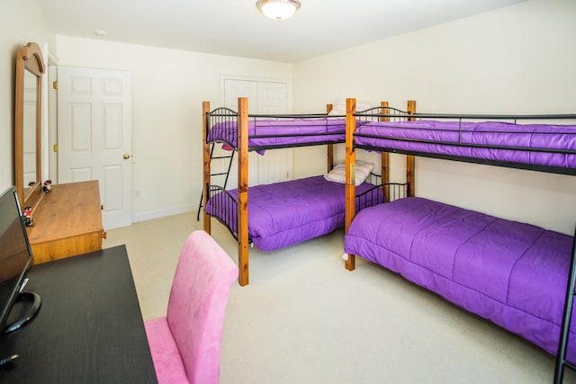 bedroom with a closet and light colored carpet