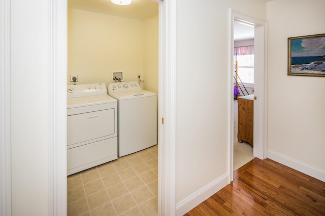 laundry area featuring electric dryer hookup, independent washer and dryer, light tile flooring, and hookup for a washing machine