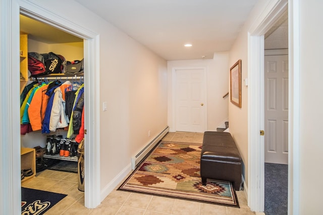 hall featuring a baseboard radiator and light tile floors