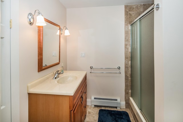 bathroom featuring vanity with extensive cabinet space, tile flooring, and a baseboard radiator