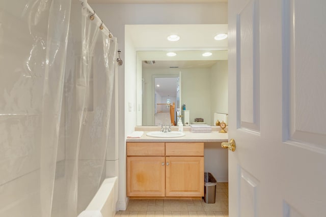 bathroom with tile floors, shower / bathtub combination with curtain, and vanity