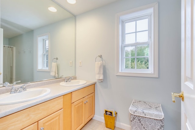 bathroom featuring tile flooring, dual sinks, and large vanity