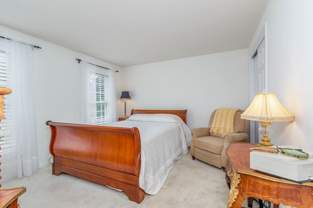 bedroom featuring light carpet