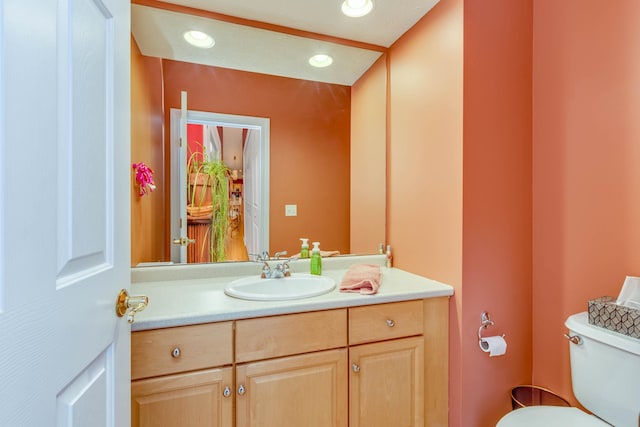 bathroom with toilet and vanity