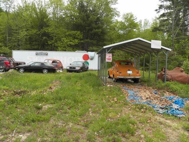 view of vehicle parking featuring a carport