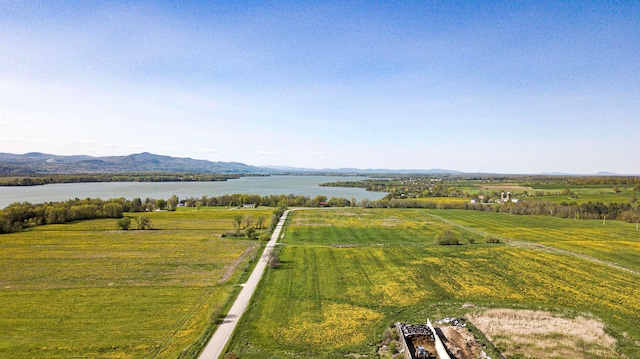 birds eye view of property featuring a water and mountain view and a rural view