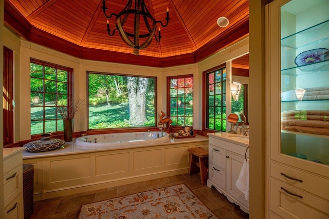 bathroom with vanity, an inviting chandelier, wooden ceiling, and a bath