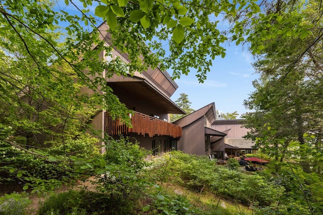 view of side of property with a balcony