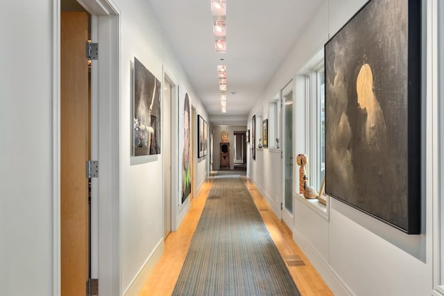 hall with light hardwood / wood-style flooring