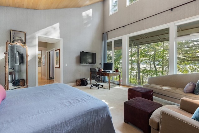 bedroom featuring a high ceiling, light colored carpet, and wooden ceiling