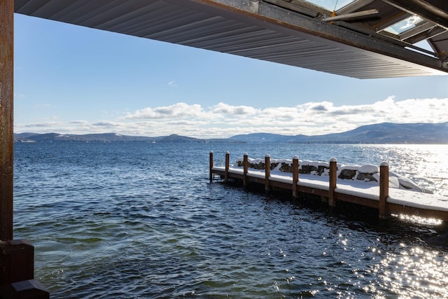 view of dock with a water and mountain view