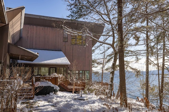 snow covered property featuring a deck