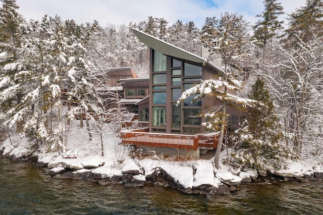 back of house with a deck with water view