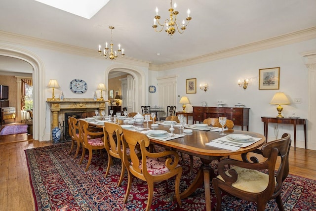 dining room with dark hardwood / wood-style flooring, crown molding, and a chandelier