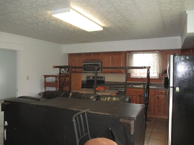 kitchen with light tile flooring, crown molding, stainless steel appliances, and sink