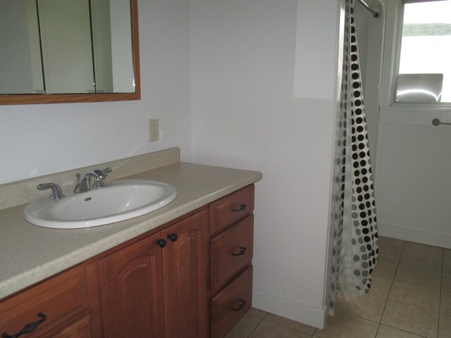 bathroom featuring tile flooring and vanity