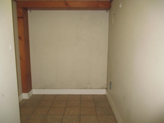 laundry area featuring light tile floors