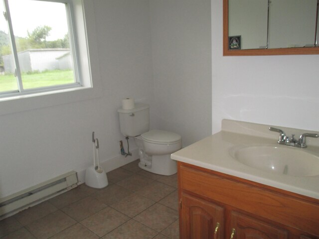 bathroom featuring toilet, tile flooring, vanity, and a baseboard heating unit